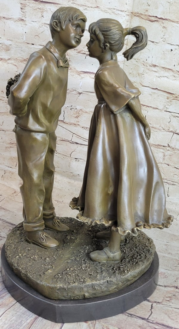 Childhood Crush On Heart Shape Bronze Statue: The innocence of childhood crushes. A young boy and girl are about to share the first kiss that they will remember for their lifetime. Hiding a bouquet of fresh-picked flowers behind his back the boy