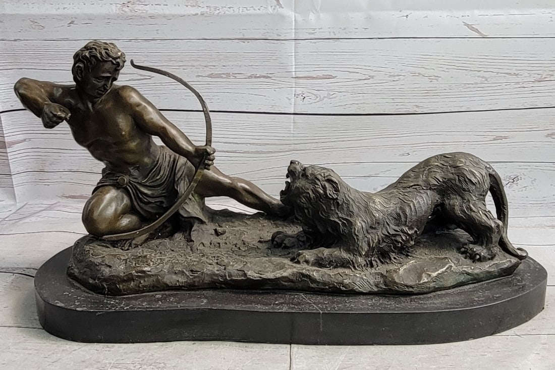 Man with Bow and Arrow Striking Lion Bronze Sculpture: This lovely sculpture of a man about to strike this lion with a bow and arrow. The lion has his mouth wide open ready to attack the man but the man wont give up to win this battle. This bronze