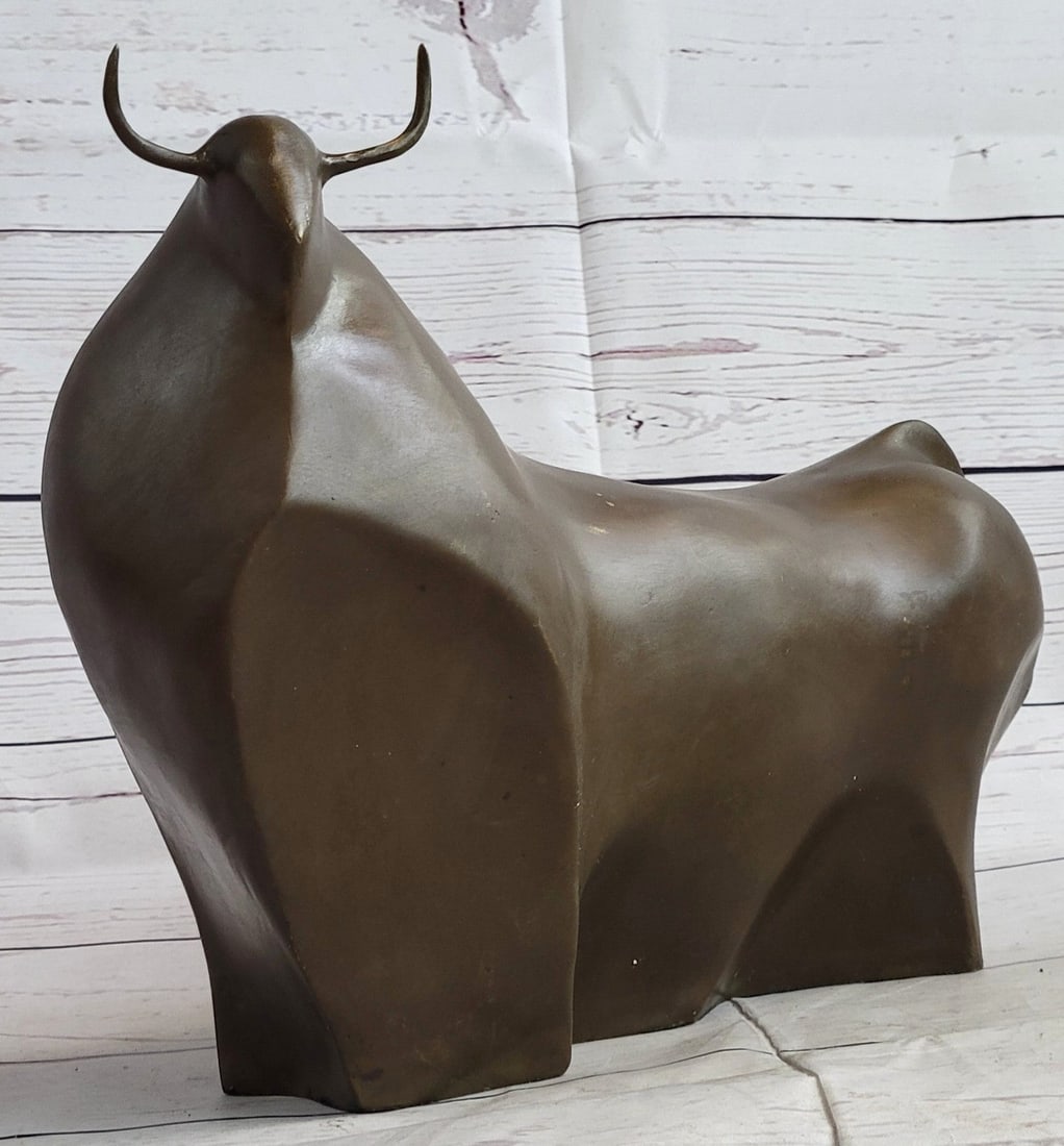 Modern Bull Bronze Figurine: The sculpture was molded by using the lost-wax casting method. Dimensions: Height 7 X Width 10 inches. Weight: 5 LBS.