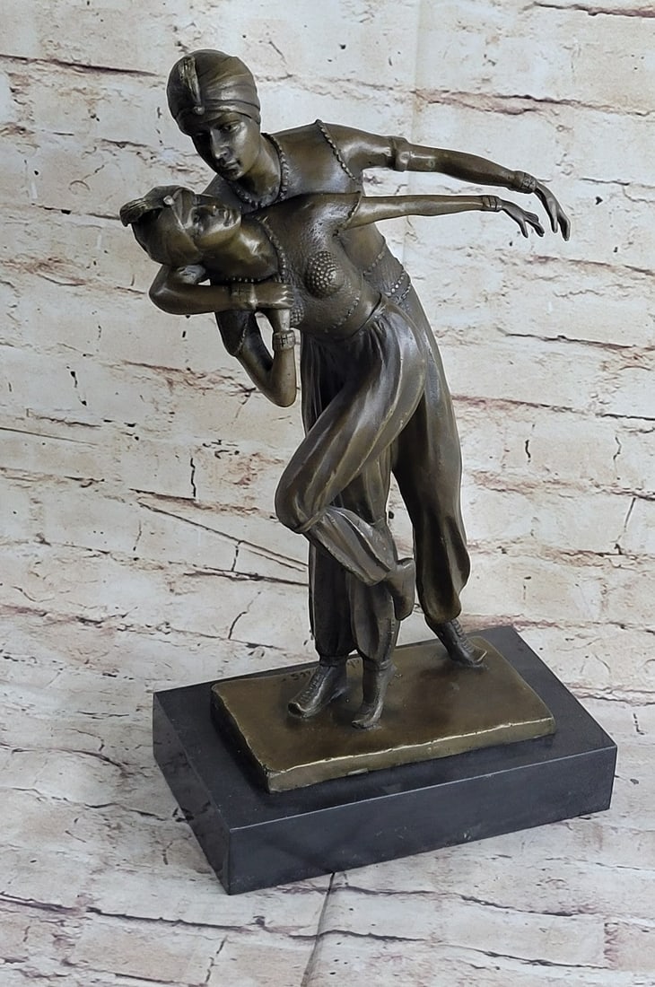 Persian Dancers Bronze Sculpture: The sculpture, known as the Persian Dancers, features a male and female dancer in mid-dance. Both are wearing elaborate costumes with harem pants that flow with their movements. The male shadows the
