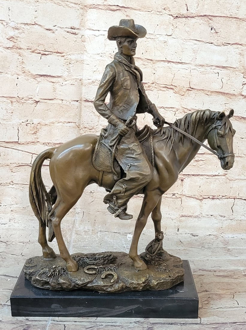 Cowboy With Hat Riding Horse Bronze Sculpture: It is the Wild Wild West. This gunslinger, comfortable on his rearing horse, looks over the horse neck to watch ahead for his enemy. He is ready to fire his weapon if need be as he travels hurriedly t