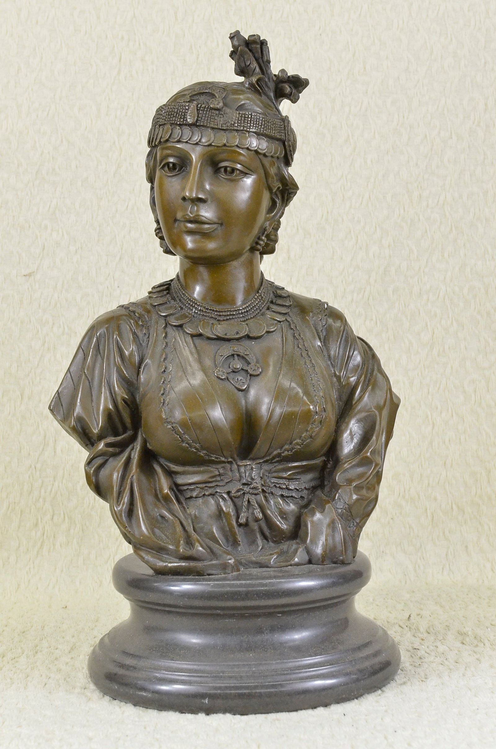 Female Bronze Bust Sculpture: Egyptian lady with majestic expression wearing earrings of semi precious stones, ornate jewelry and headdress, and long braids hanging down back. Cordier traveled to the far corners of the earth