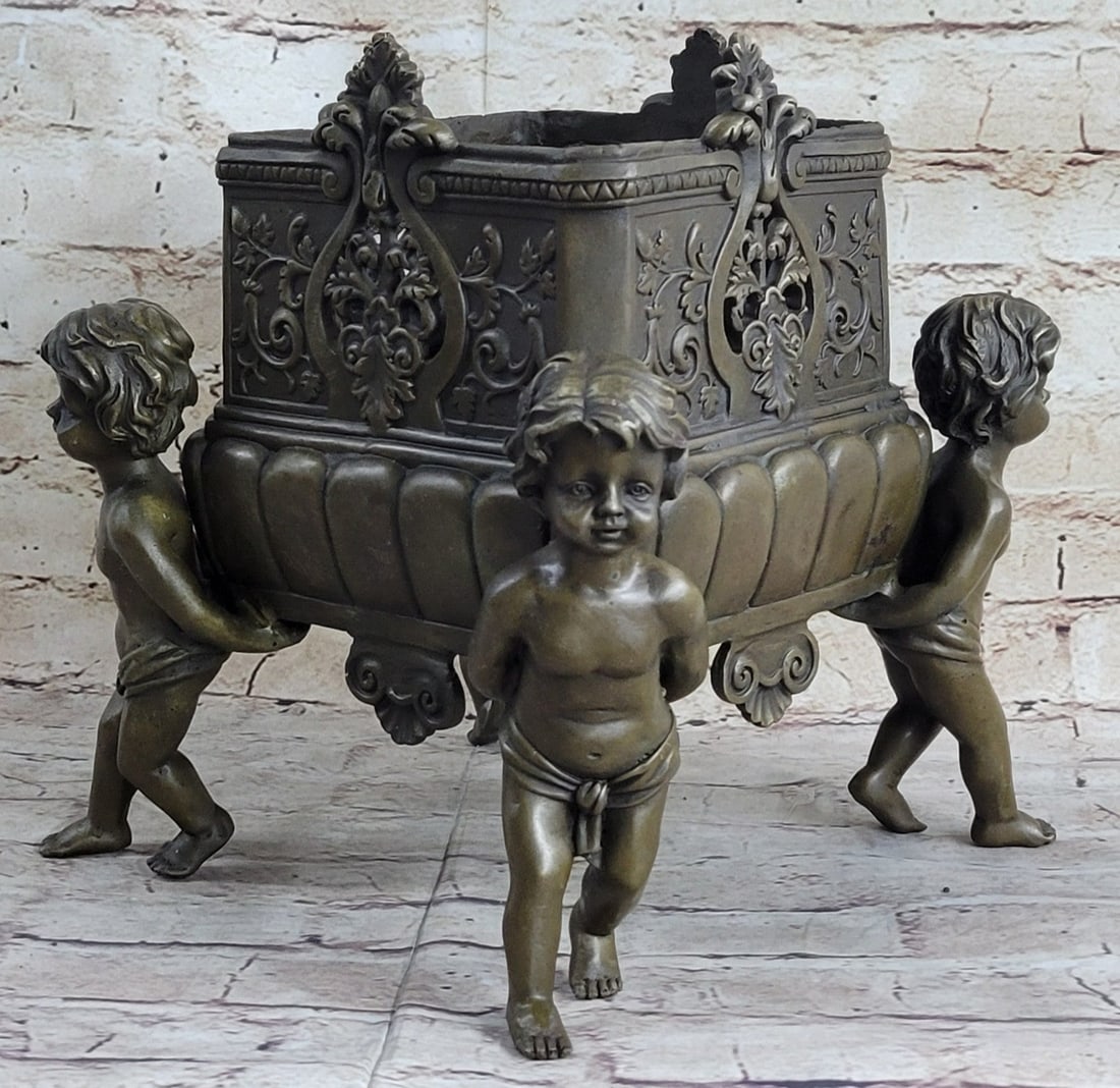 Four Identical Boy Planter Bronze Sculpture: The four identical sides of planter are flawlessly brazed together at corners. Boys gracing corners are perfectly finished. Detail on planter is deep and hand-chiseled. This sculpture was cast using