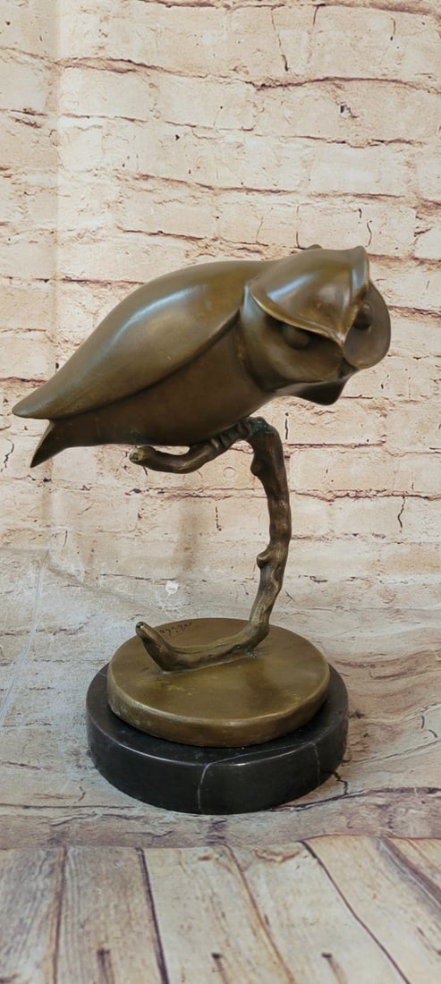 Abstract Modern Art Owl Bronze Sculpture: A quaint owl rests upon his perch, looking out into the night sky. His innate ability to listen keeps him occupied as he listens to the sounds of the night, waiting to hear the scurry of a mouse so