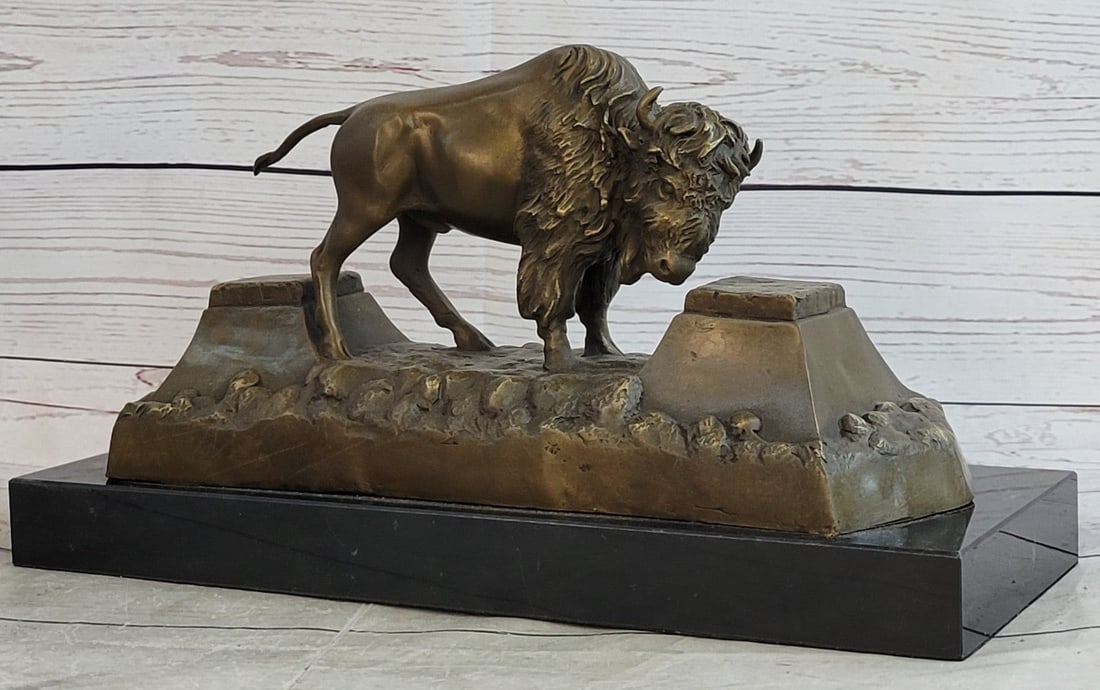 American Buffalo Bison Bronze Sculpture: The American buffalo, also known as the bison, is a large animal once known to be dangerous to men after the brown bear. Now, they usually take on a lazy, peaceful attitude although there have been