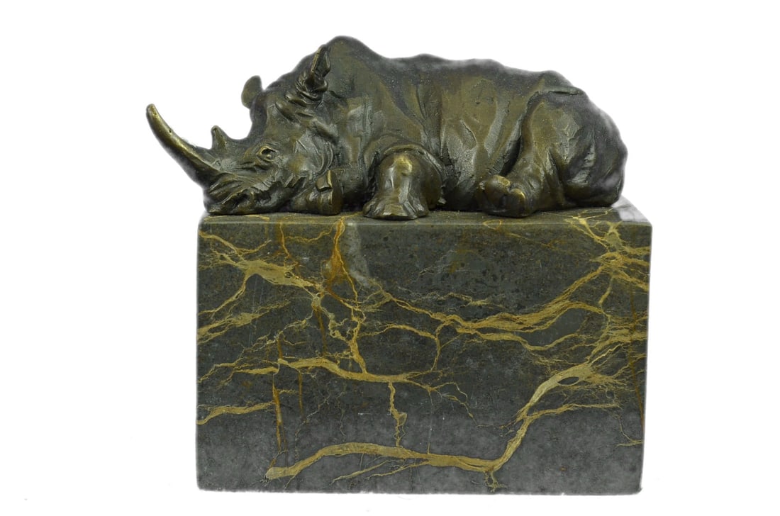 Rhino Bronze Sculpture: This Rhino rests with his nose high in the air and his legs are planted on the ground with an immovable stance. Rhinos are known for using body language to communicate. Typically rhinos never lift the