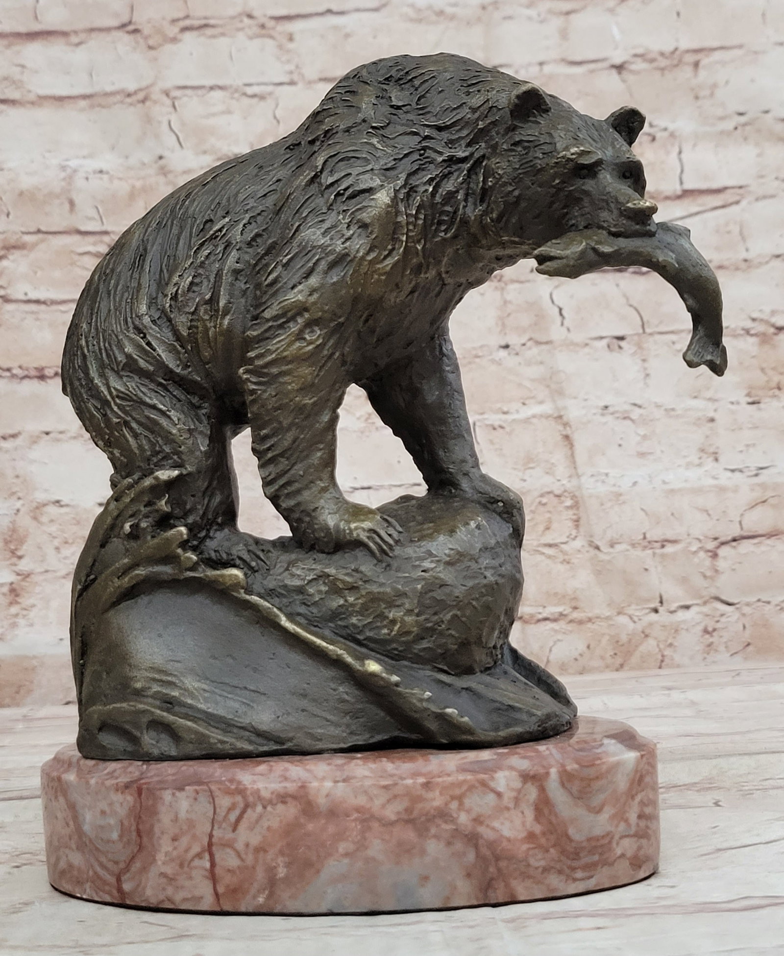 Young Bear with Catch of The day Bronze Sculpture: To this day, bears play a prominent role in the arts, mythology, and other cultural aspects of various human societies. The bear was thought to possess diplomacy equal to its great strength and it is