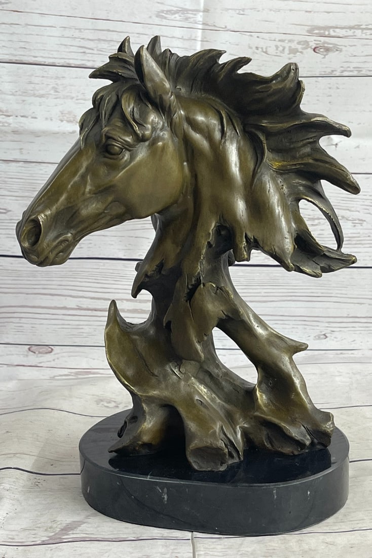 Horse Head Bronze Sculpture: This bronze bust of a horse is filled with a raging vibe of energy. The horse seems to be excited or spooked. He bends his head down towards his body as his hair flows upwards as if he is bucking and 