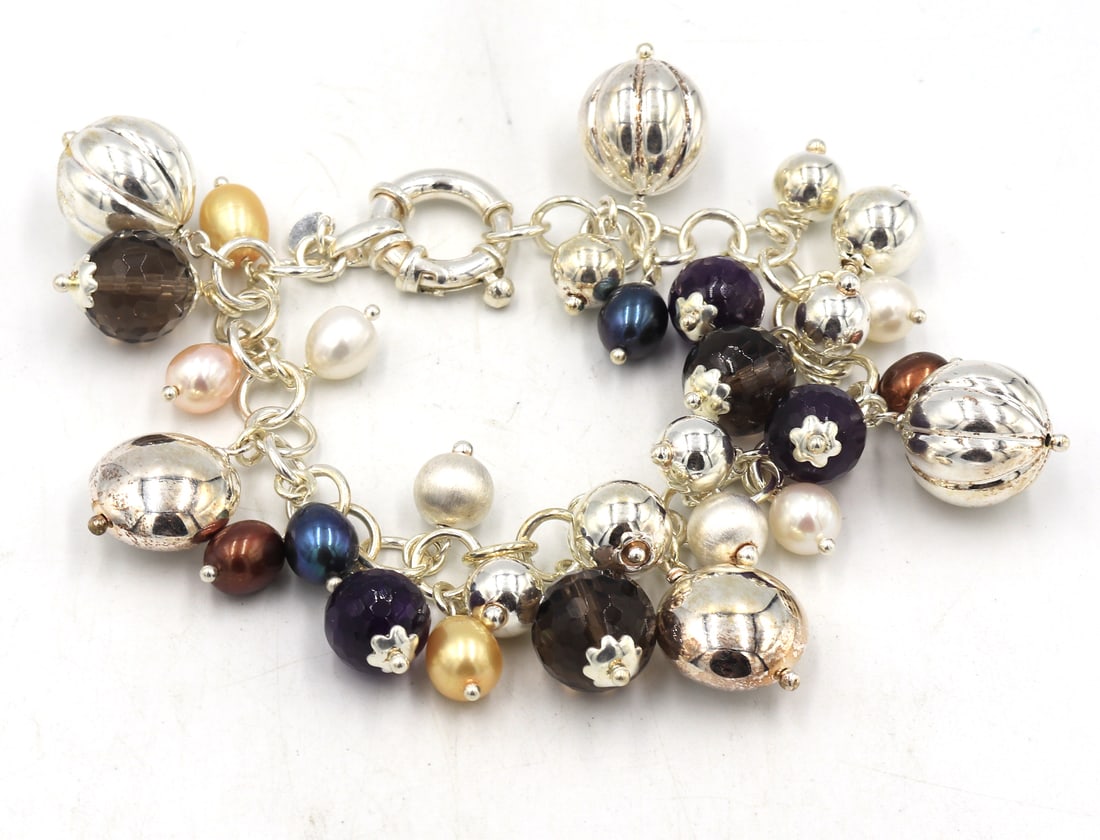 925 Sterling silver ball charms bracelet: 925 Sterling silver ball charms 7 inches bracelet with spring ring clasp. Total weight of bracelet is 46.9 grams.