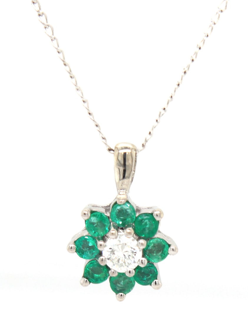 14kt White gold diamond and Emerald flower pendant on chain necklace: 14kt White gold diamond and Emerald flower pendant on 18 inches chain necklace. Total weight of necklace is 1.80 grams.