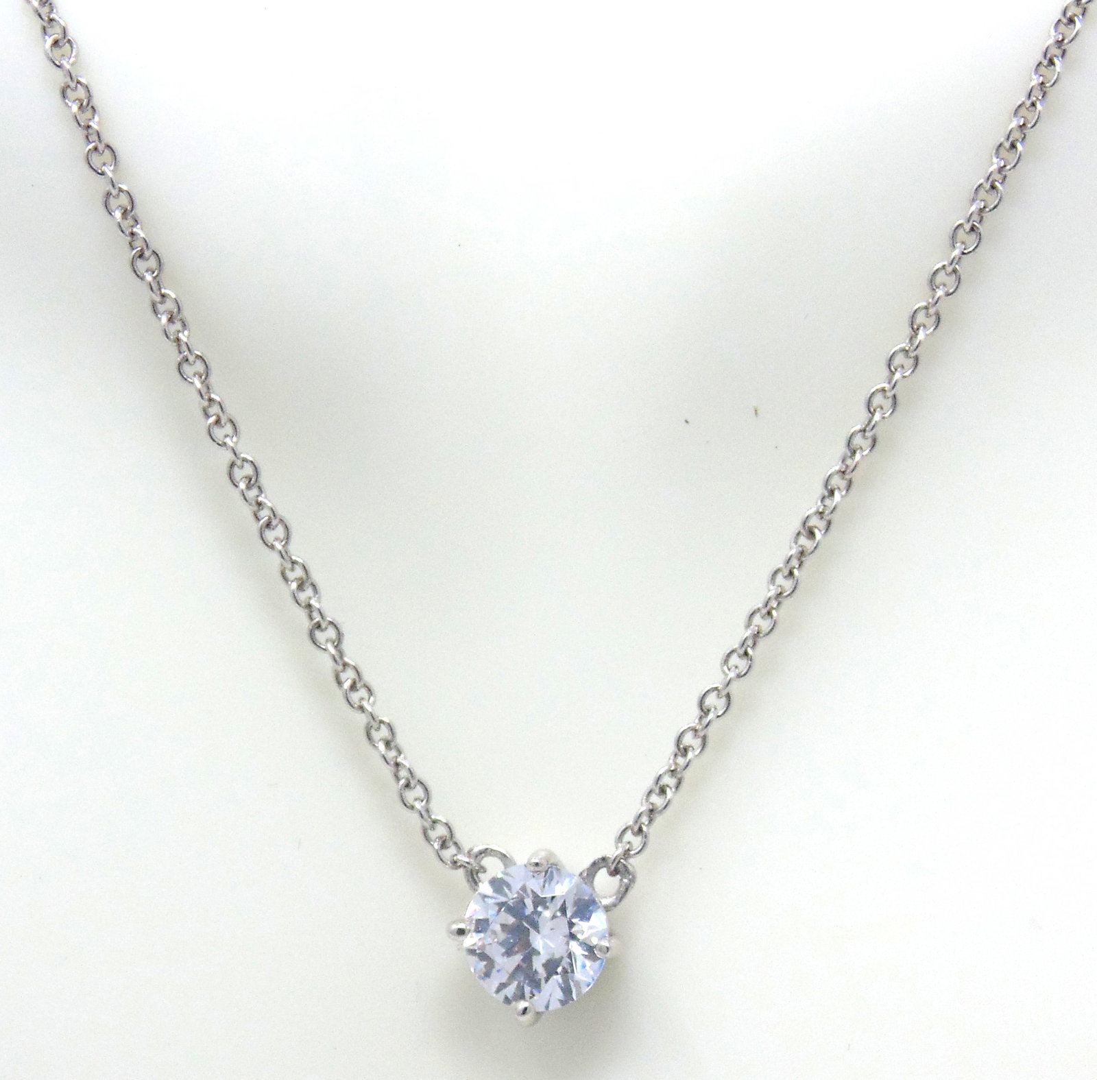 925 Sterling Silver Cubic Zirconia Necklace: 925 Sterling Silver Round Cubic Zirconia Pendant on 16-18" Chain Necklace. 2.77 Grams.