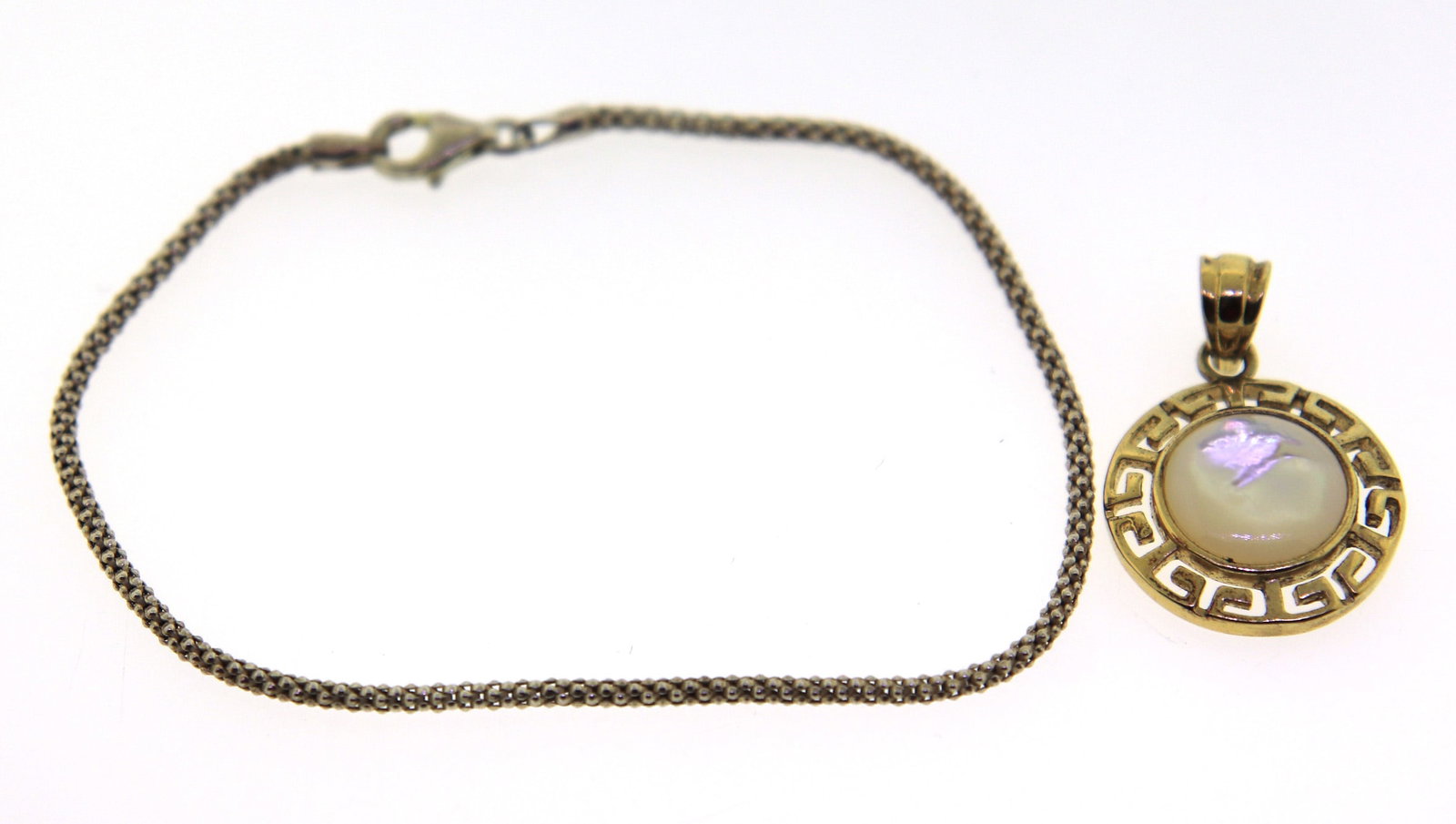 925 Sterling Silver Bracelet with Pendant: 925 Sterling Silver 7" Woven Bracelet with Sterling Silver Pendant. Total weight of Lot 6.9 Grams.