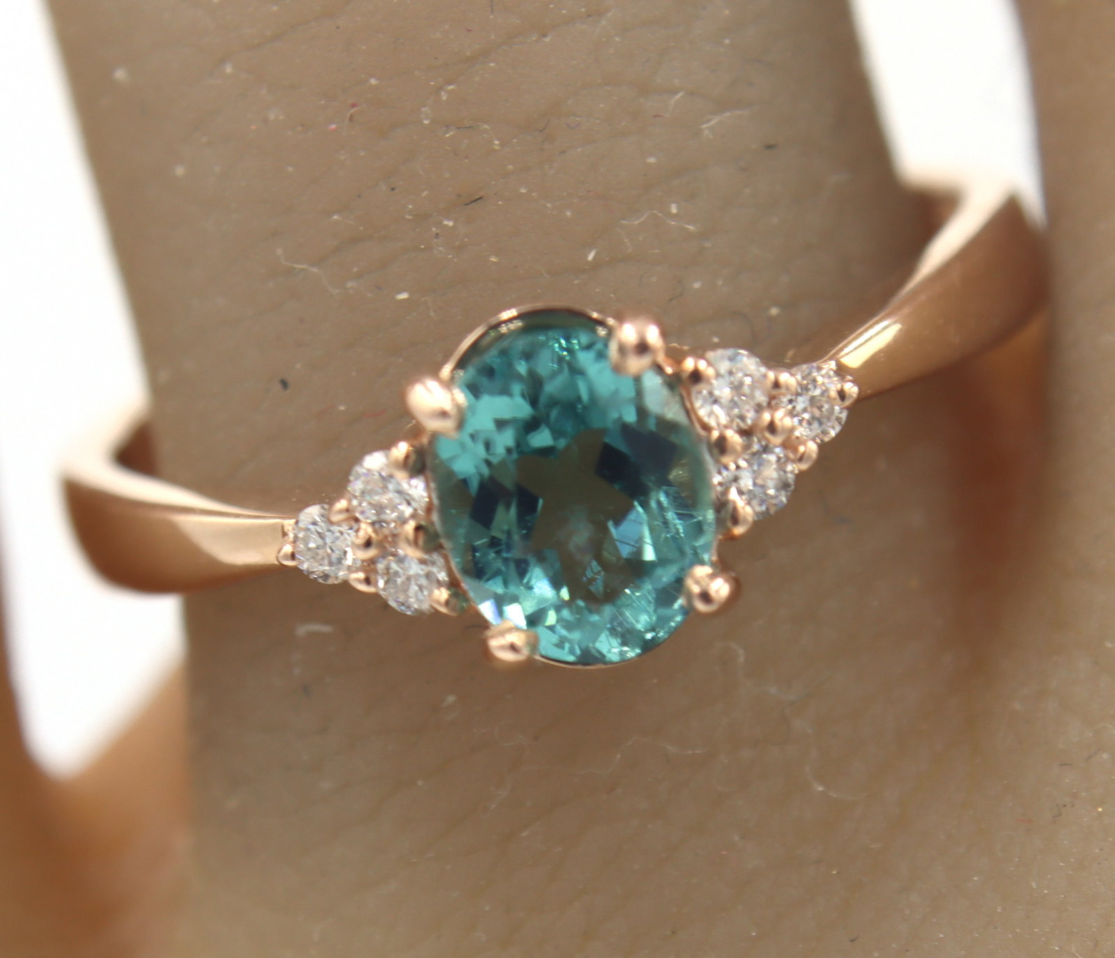 14kt Rose Gold oval Blue Zircona and Diamond Ring: Fantastic 14kt Rose Gold oval Blue Zircona and Diamond Ring. Total weight of Ring 2.50 Grams. Ring Size 7"