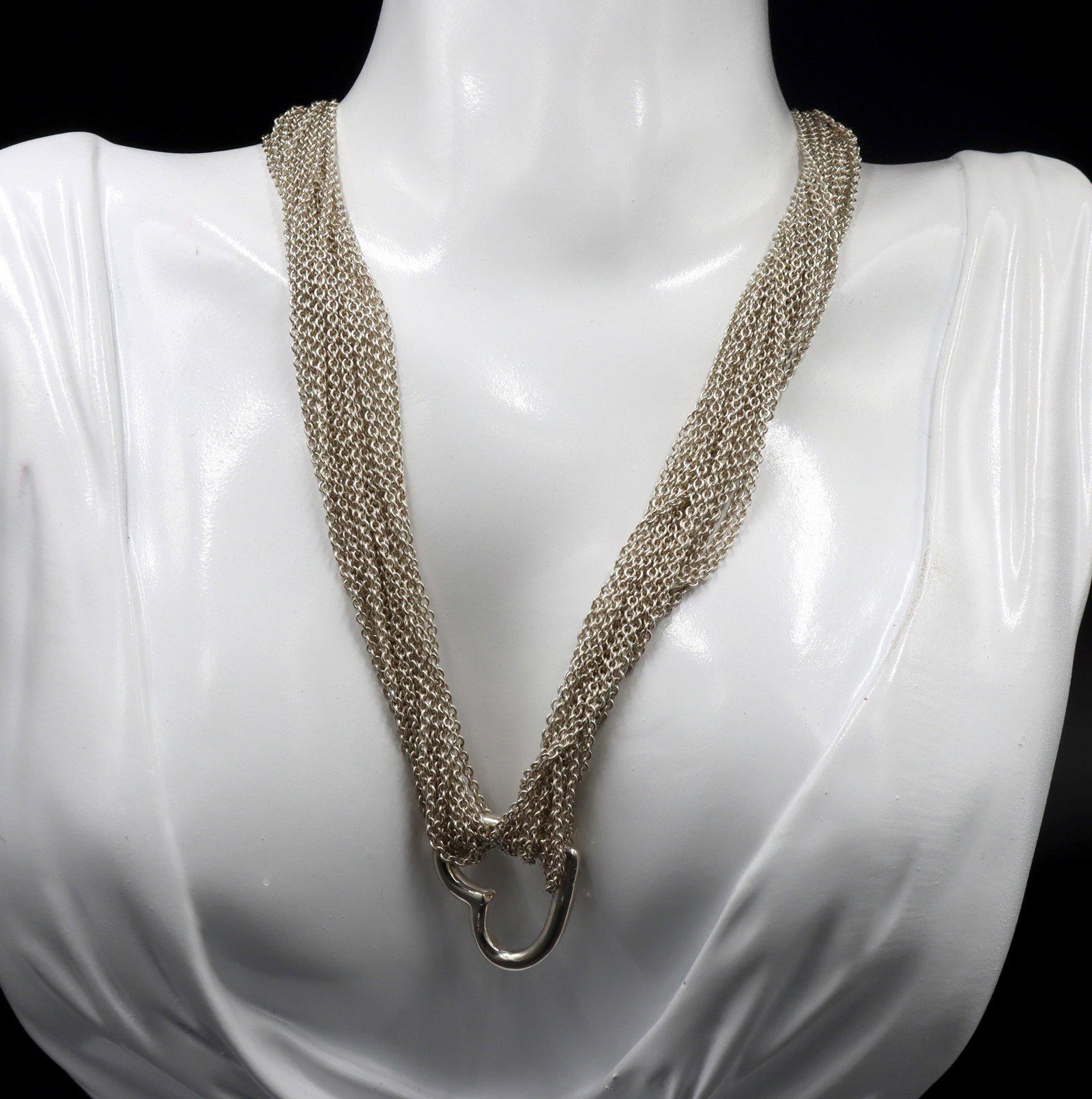 Tiffany & Co multi strand mesh open heart pendant necklace: Tiffany & Co multi strand mesh open heart pendant 16-inch necklace in 925 sterling silver. The total weight of the necklace is 52.40 grams.