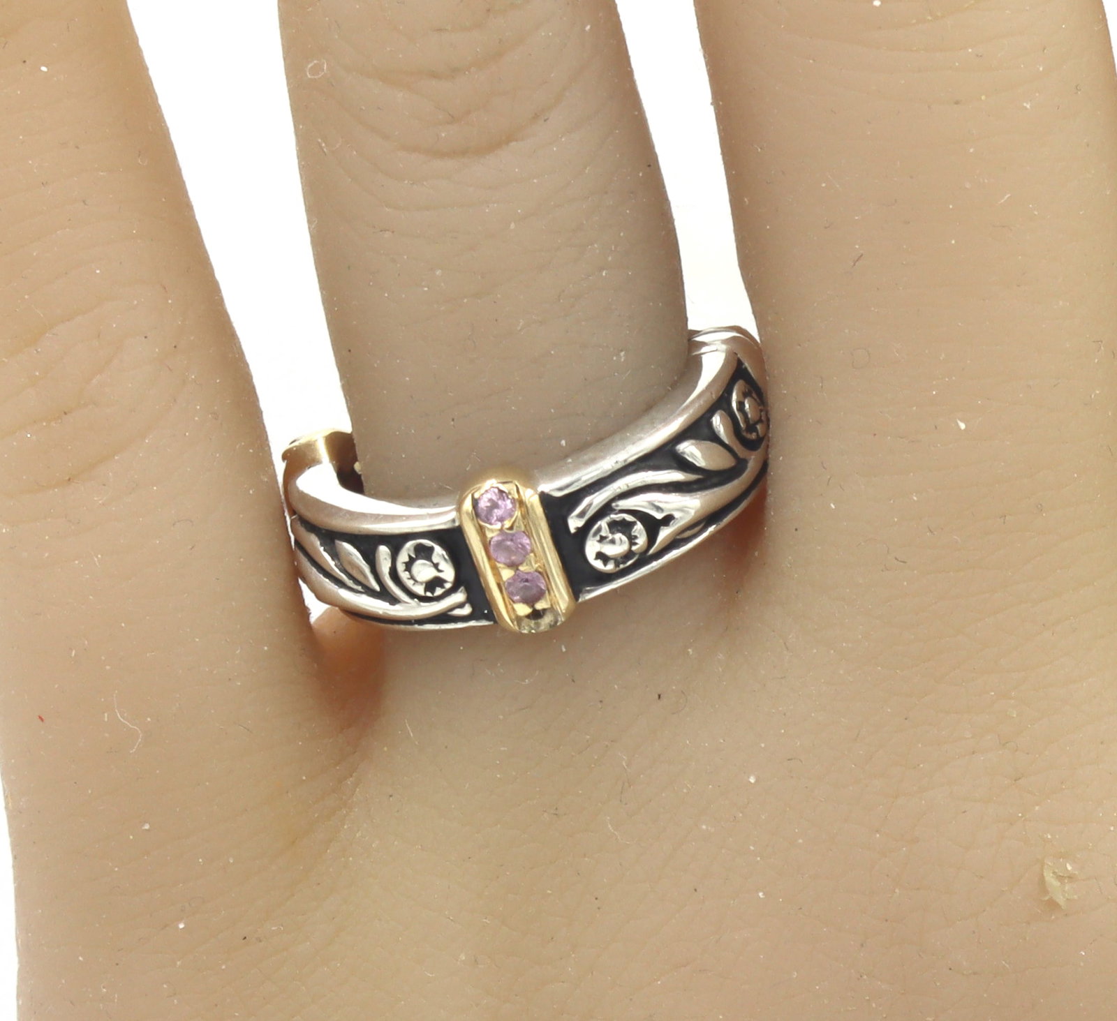 925 Sterling silver two tone band with pave pink sapphires: 925 Sterling silver two tone band with pave pink sapphires. The total weight of the ring is 7.22 grams. Ring size 5.5".
