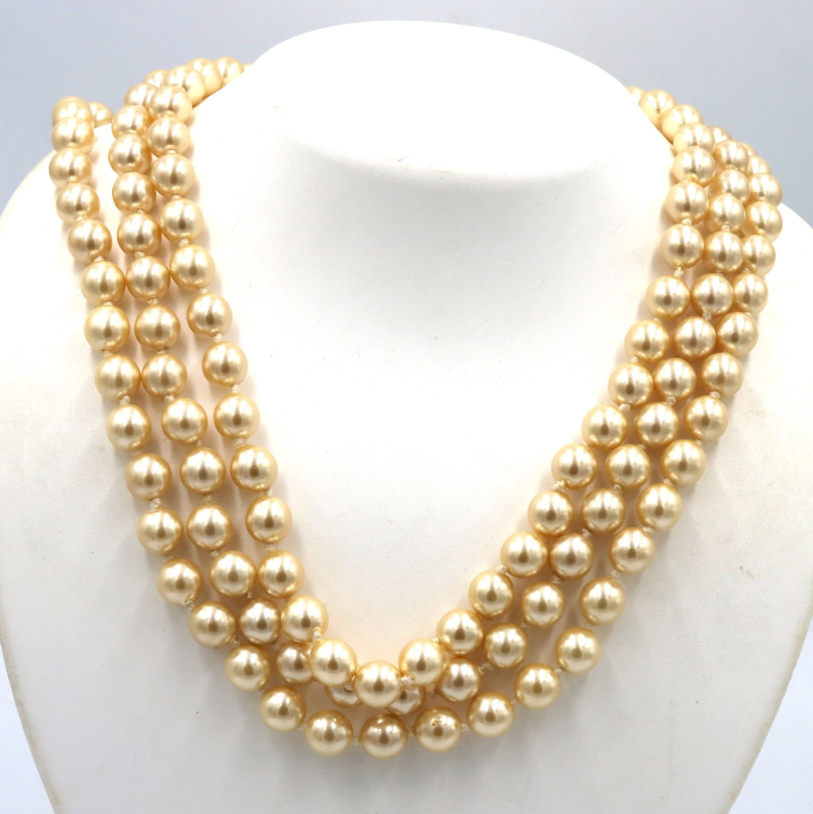 Faux pearl necklace: Faux pearl 3 strand 19-inch necklace. The total weight of the necklace is 122 grams.