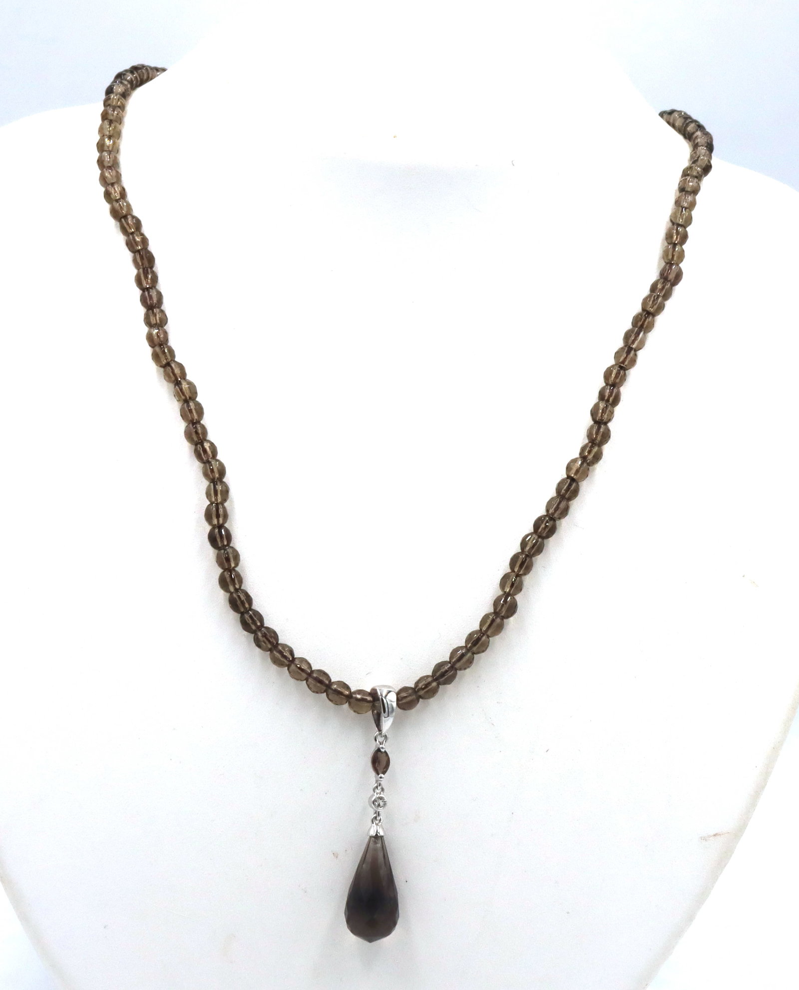 Pear shaped smokey quartz pendant on beaded necklace: Pear shaped smokey quartz pendant on 18-inch beaded necklace in 925 sterling silver. The total weight of the necklace is 14.2 grams.