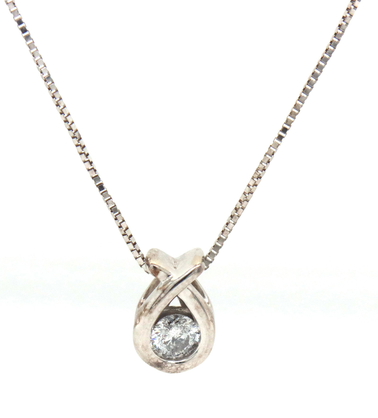 10kt White gold 0.15ctw diamond pendant on chain: 10kt White gold approximate 0.15ctw round brilliant cut diamond pendant on adjustable 18-20-inch box chain necklace. The total weight of the necklace is 1.76 grams.
