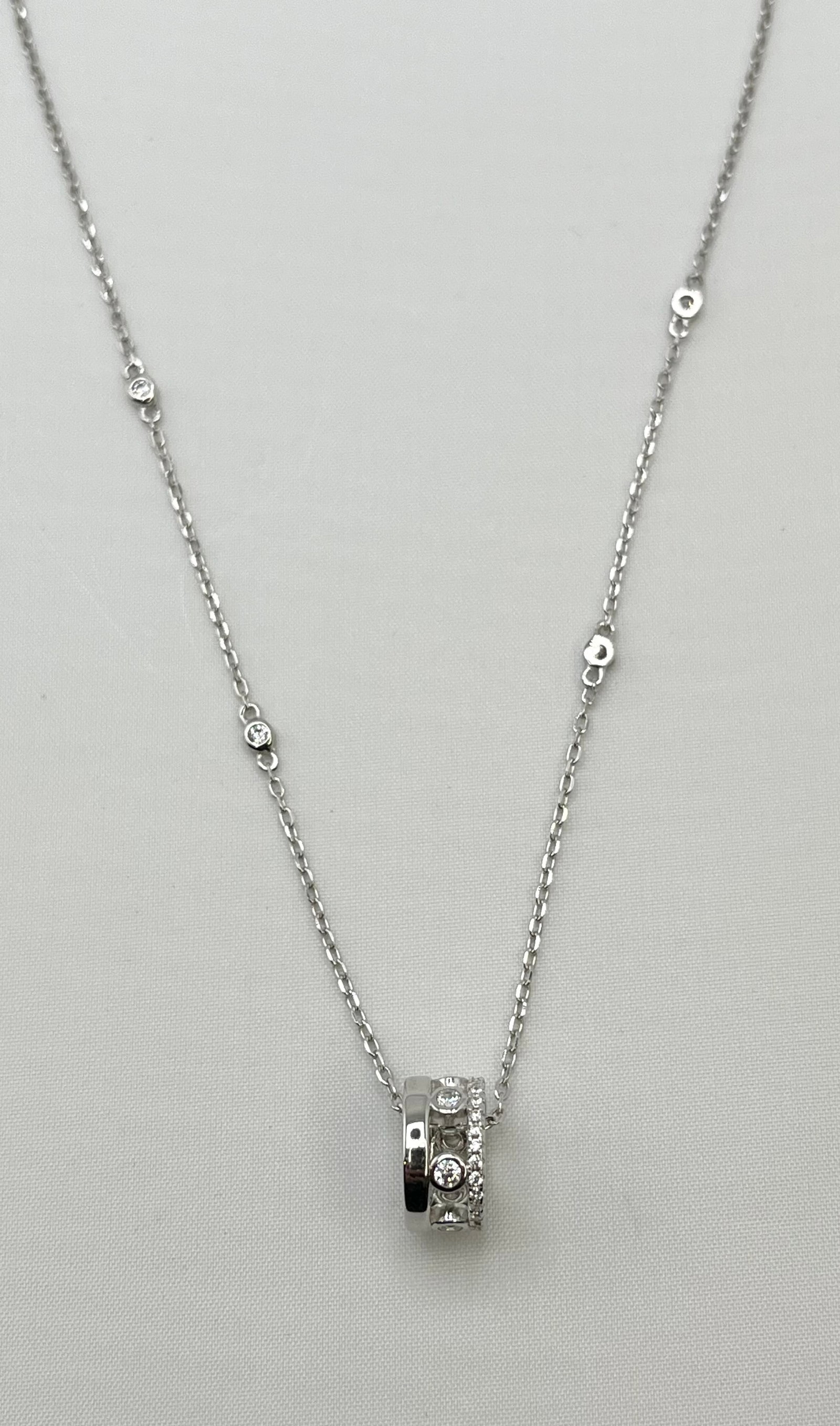 925 Sterling Silver Interlocking Circle With CZ Details Pendant And CZ Station Chain Necklace: 925 Sterling Silver Interlocking Circle CZ Pendant With Chanel Set,? And CZ Station Detail? Chain Necklace. 18 inches. 4.2 grams