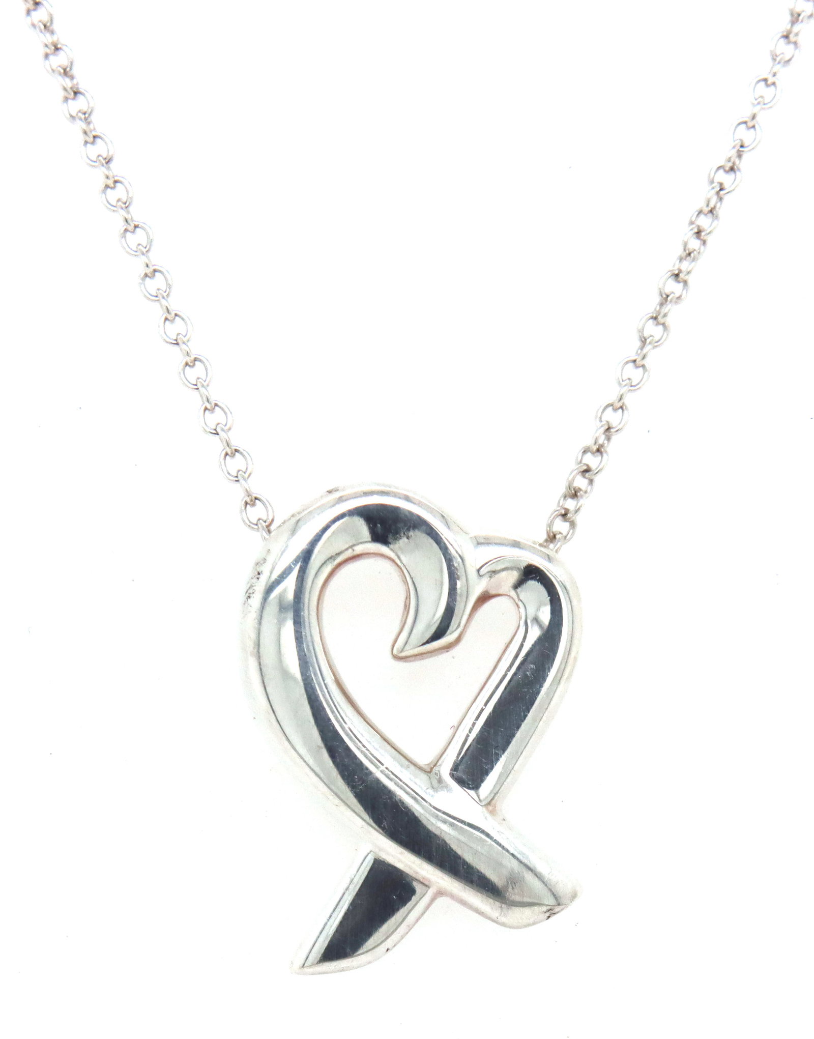 Tiffany & co Paloma Picasso loving heart pendant on chain: Tiffany & co Paloma Picasso loving heart pendant on 18-inch chain necklace in 925 sterling silver. The total weight of the necklace is 3.10 grams.