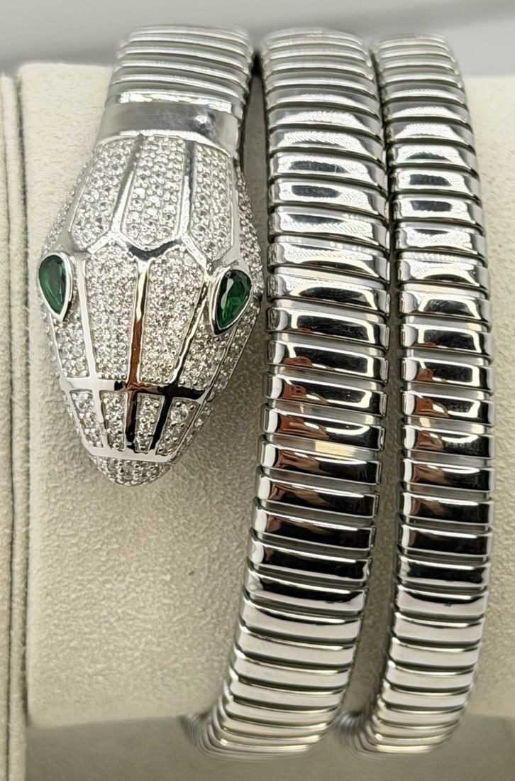 925 Sterling Silver And Stainless Steel Crystal Triple Wrap Snake Bracelet: 925 Sterling Silver & Stainless Steel Triple Wrap Snake Bracelet with Crystal Head and Green Eyes ? Size M. This striking triple-wrap?snake bracelet is crafted from a refined combination of 925 sterli