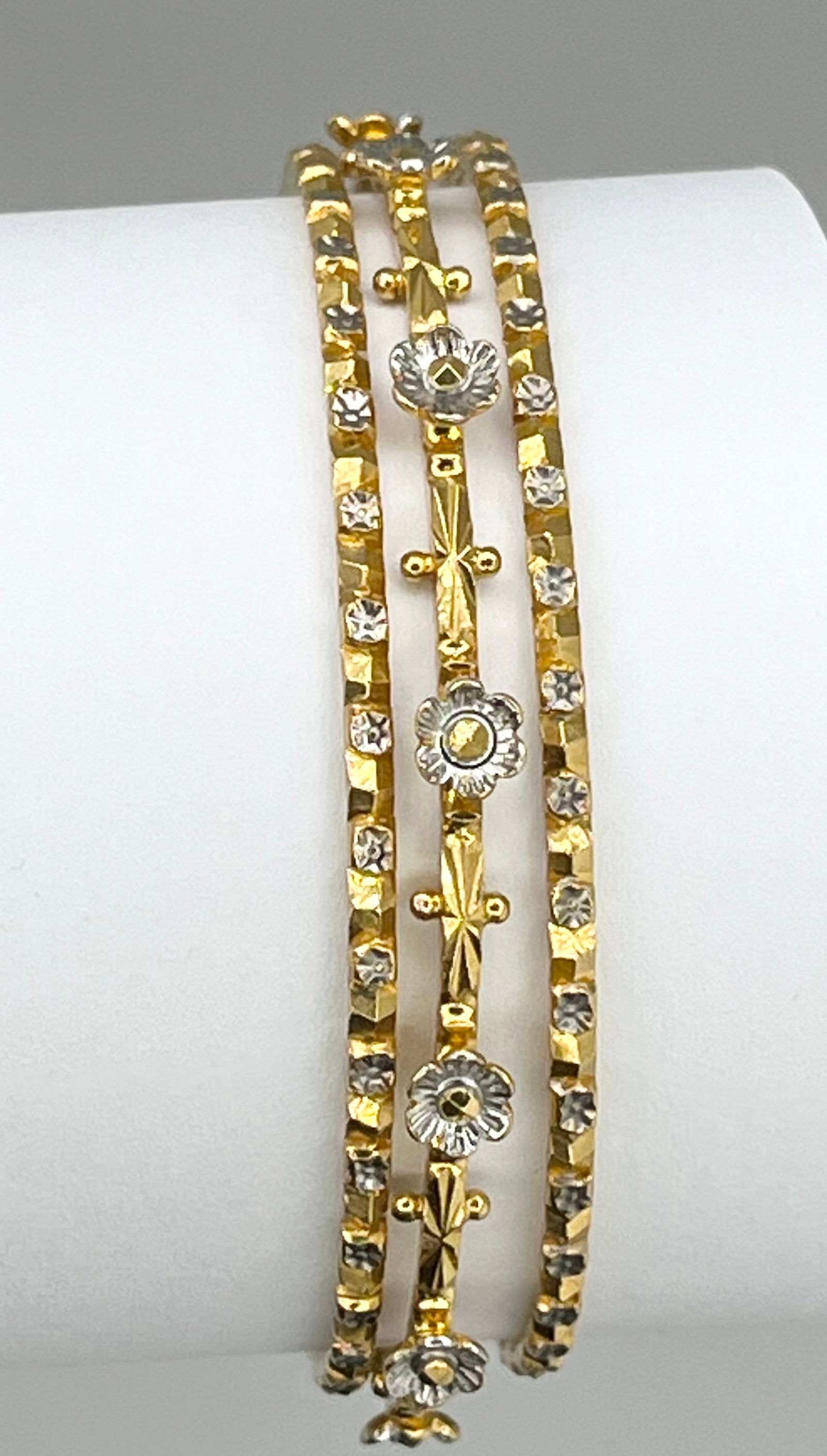 22KT Yellow Gold Hand Made Set Of Three Gold And White Flower Motifs Bangles: 22KT Solid Hand-Made Yellow Gold Set of Three White Gold Flower Motifs Design Bangles Can Be Worn Together Or Alone. Size M. 36.5 Grams