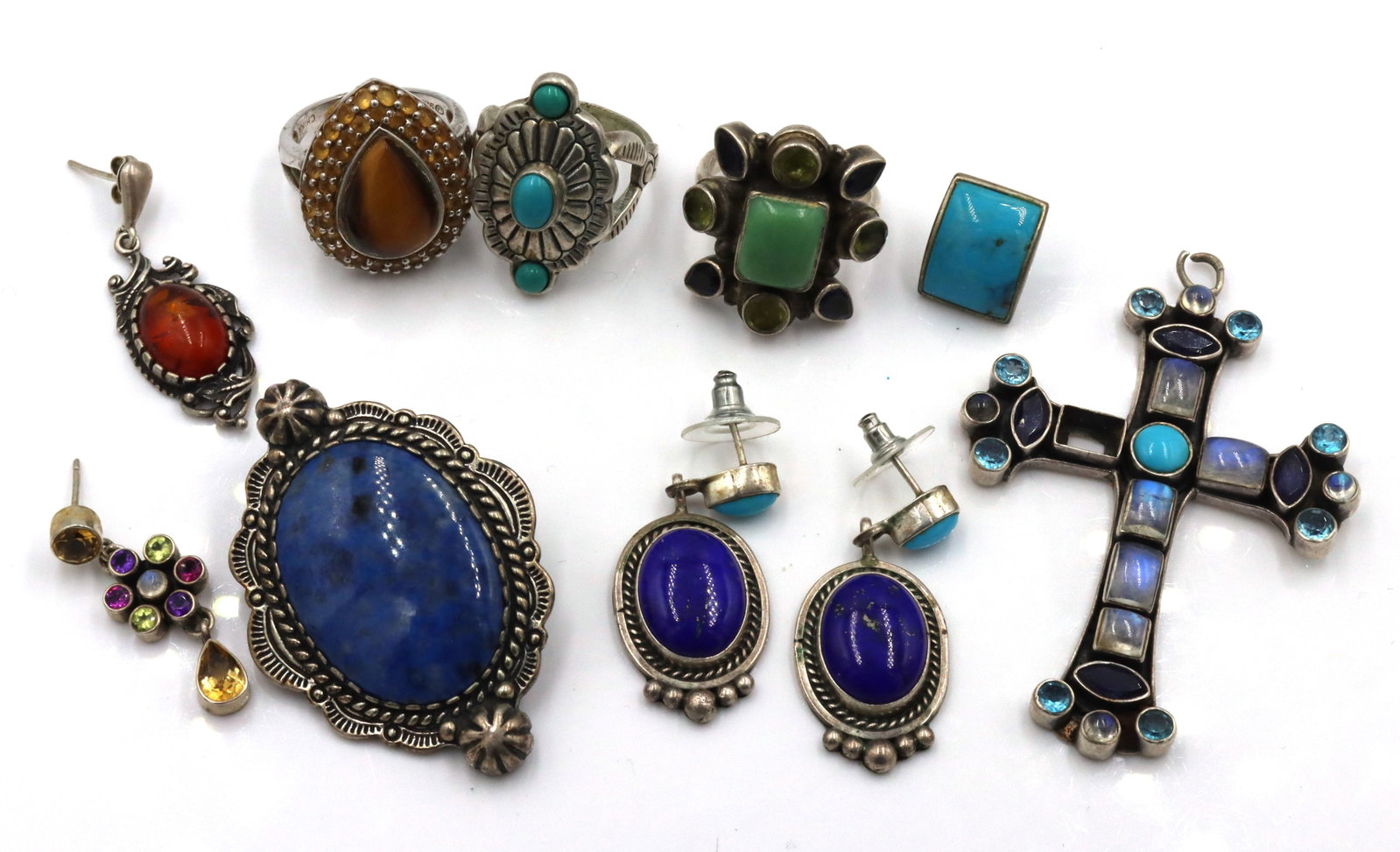 Group lot of Vintage 925 sterling silver lapis and turquoise mixed jewelry: Group lot of Vintage 925 sterling silver lapis and turquoise mixed jewelry. The total weight of the lot is 89.1 grams. Cross pendant missing one stone.