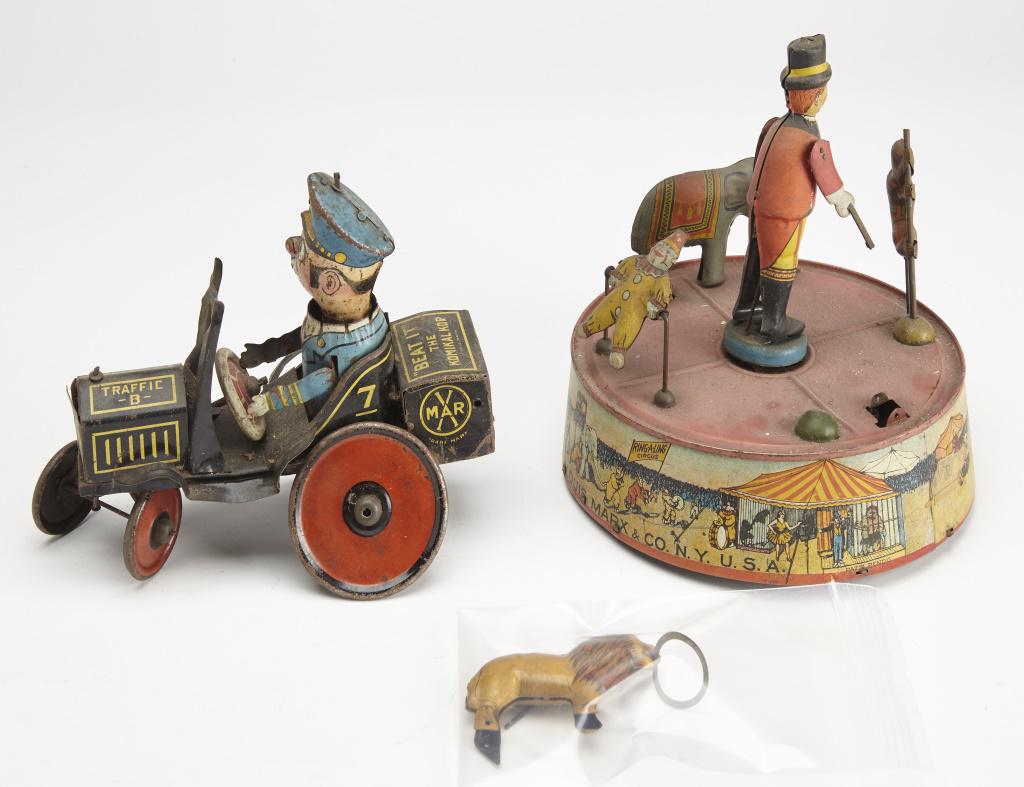 Toys-Marx Beat It and Ring-a ling Circus: Two antique toys. Marx Beat It and Ring-a ling Circus. Beat It: H 6-1/2", W 7-1/2. Circus: H 7-3/4", Dia. 7-3/4". Beat it is over-wound. Circus winds but does not operate properly. Lion and pin are pr