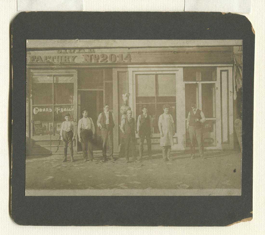 Cigar Store Indian Photograph - Cigar Factory: Cigar store Indian photograph - Cigar Factory. Circa 1890. Original photo on original mount. Overall size 7" x 7-7/8". Image size 5" x 7". Excellent condition, some losses to corners of backing.