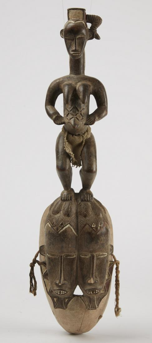 African Mask with Twins: Old carved African mask,. H 25-1/2", W 6", D 4"