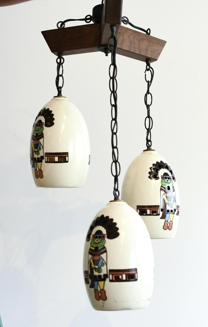 MCM Southwest Theme Hanging Fixture: Interesting mid century modern hanging light fixture with Native American theme design. Glazed ceramic, with wooden top cross bracket, circa 1960. H of each fixture 11" one signed MH