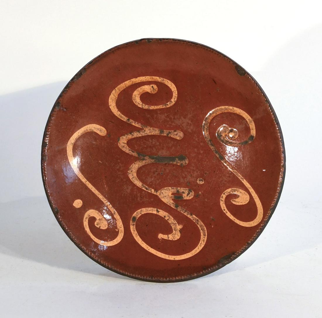 Redware Slip Plate: Redware slip plate. 19th century. Imperfections. Dia 10-1/4".