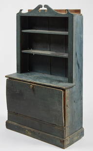 Child's Cupboard in Original Blue Paint: Very fine 19th century child's cupboard in beautiful original blue paint. Open top with drop down lower panel door. Exceptional condition. 1/2" of the small ear on right of the crest is replaced.