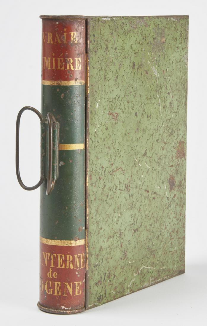 Tin Book Shaped Lantern: Tin book shaped lantern or viewer with candle holder. Closed size L 10-1/2" W7-3/4"D 2" Copy and paste this link for high-res images. https://www.dropbox.com/sh/sbdlvhgmxbntp4u/AABq7Mh0Ob3d7SabsgDwZYO