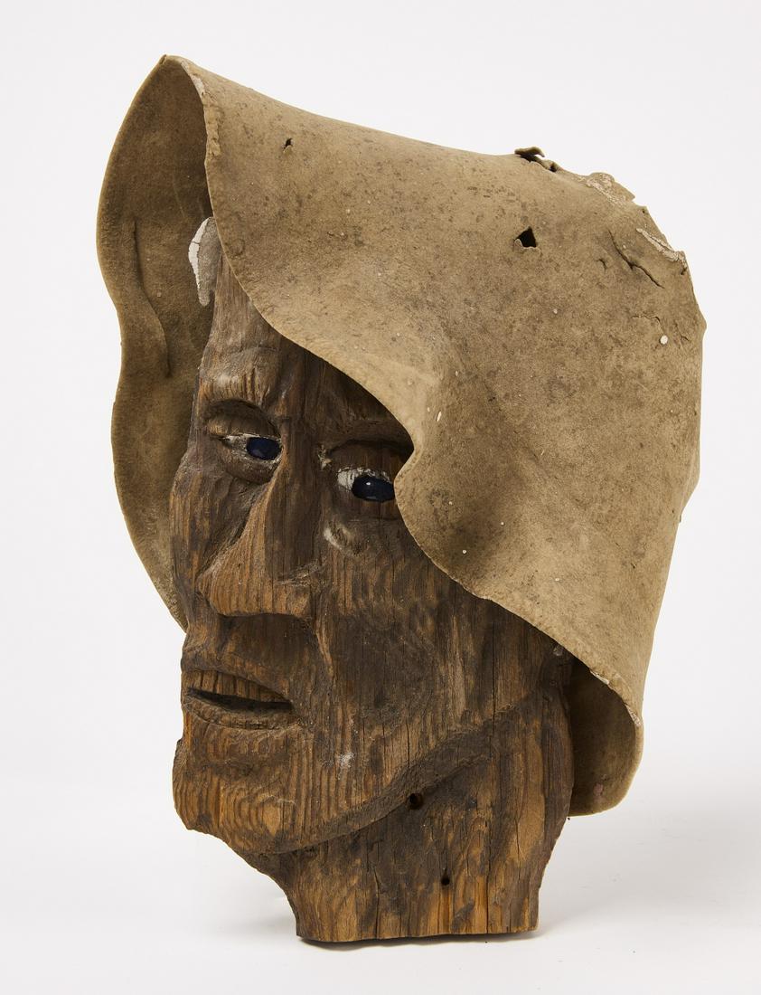 Carved Man's Scarecrow Head with Felt Hat: Scarecrow head. Carved wood and fabric. Mid west U.S. Circa 1900. Life size carving in pine with glass eyes. Original surface. Custom wall mount. H 12" W 10" Ex. Ted and Carol Hayward collection. Plea