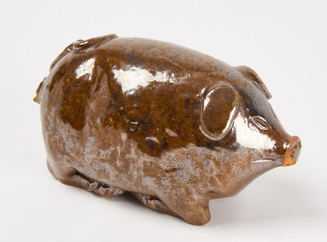 Redware Pig Flask: Redware pig flask, manganese glaze. Attributed to Andrew Kirkpot Pottery, Vermilion, Illinois. H 3-1/8" W 5-1/2" D 2-3/4". Condition: Excellent. Minor chip on tail and glaze loss to snout. Copy and pa