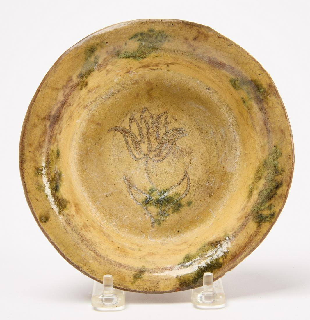 Redware Bowl: Redware bowl. Tin glaze with sgraffito tulip design in center of bowl. Virginia, circa 1830. D 6-1/8" H 1". Condition: Excellent. Small rim chip. Some light residue. Provenance: Stratford Morton, St L