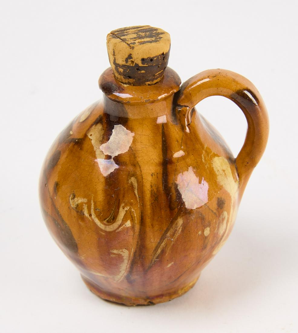 Miniature Redware Jug: Miniature redware jug with manganese and yellow slip decoration. Western New York State, circa 1820. H 2-1/2" D 2-1/2". Condition: Excellent without restoration. Any minor imperfections likely occurre