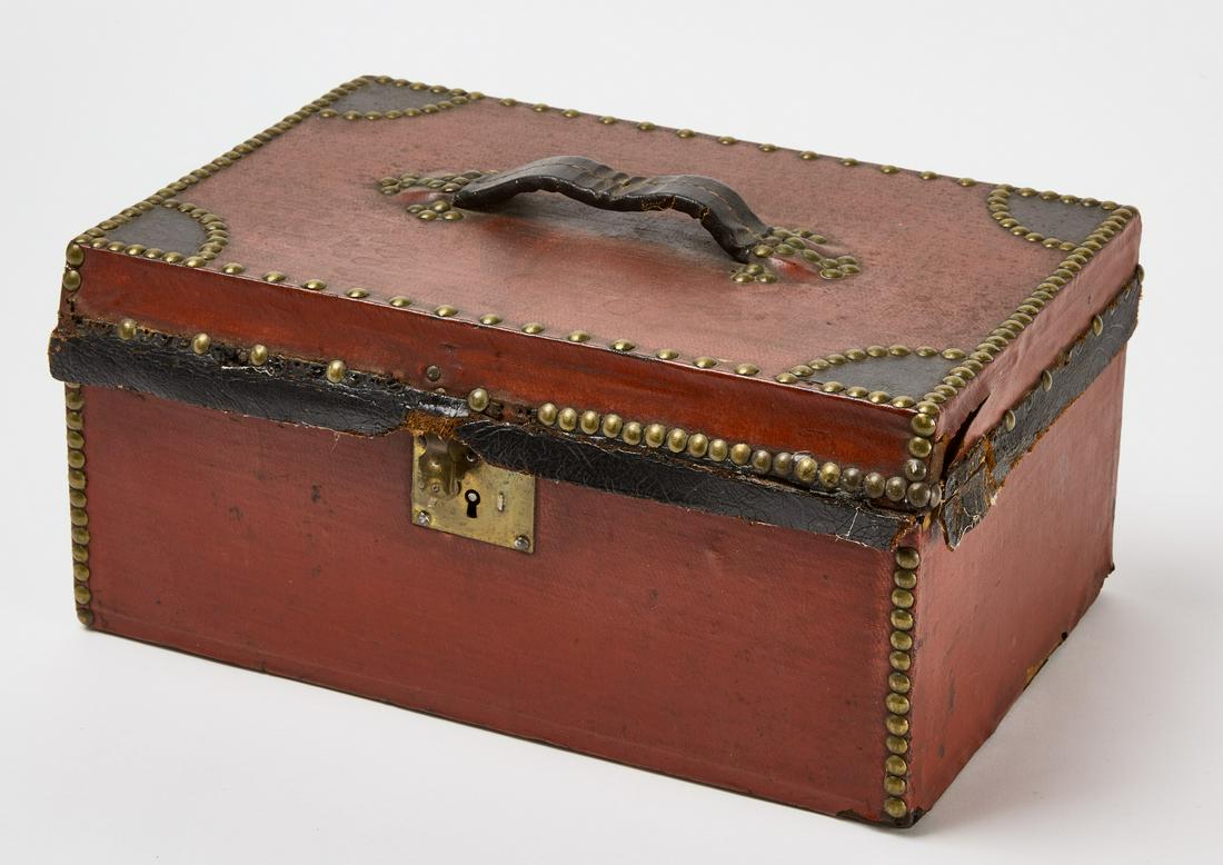 Canvas Red Box with Leather and Brass Tack Border: Canvas red box with leather handle and trim with brass tack borders, key inside box. L 14" H 7" D 9". Condition: Excellent condition. Copy and paste this link for a high-res image: https://www.dropbox
