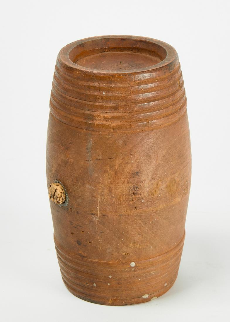Powder Keg with Salmon Paint: Good antique treen powder keg with original salmon paint. Lead lined pouring hole. American. Early to mid 19th century. Condition: Excellent original condition. H 7-1/4" W 4-1/2". Copy and Paste this