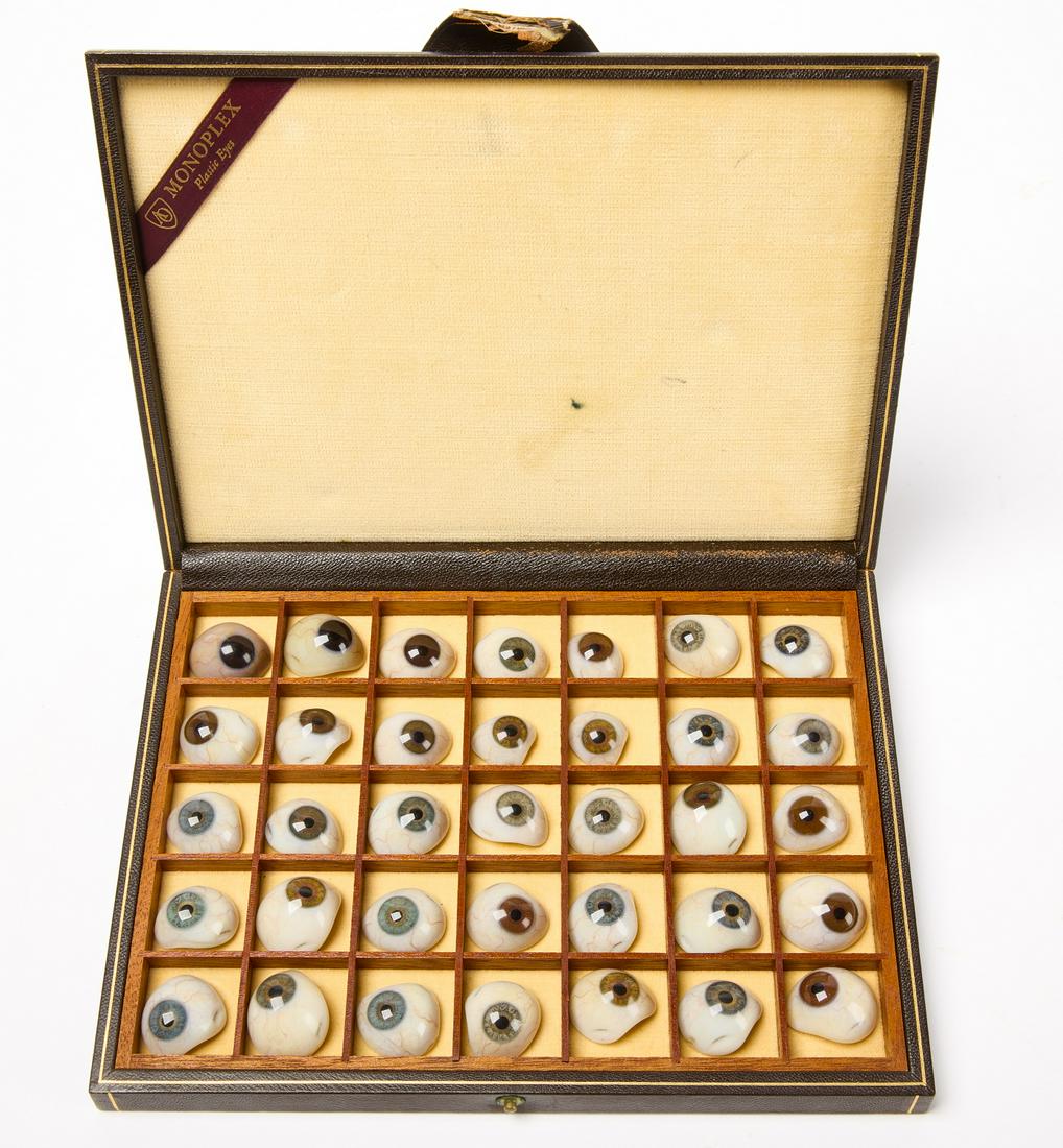 Prosthetic Eyes: Small dark brown box with 35 prosthetic eyes of different colors. Latch has broken off box. H 9-5/8" W 7-1/4 D 1-1/2". Link for high-res image: https://www.dropbox.com/sh/8ykxgciac7pw1qm/AABvbiIC6SApc