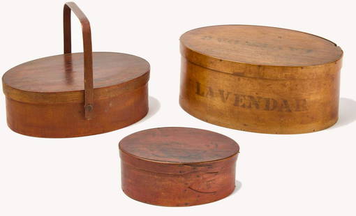 Three Shaker Boxes: Large shaker box with "Lavendar" stenciled on lid and side. Shaker box with red stain. Shaker sewing box with swing handle. Shaker H 5-3/8" W 13-1/2" D 9-5/8". Lavendar H 3-1/2" W 9-1/8" D 6-1/8". Swi