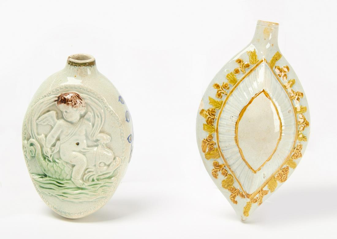 Two Prattware Flasks: Pair of Prattware flasks. One with cherub riding a dolphin. One in lozenge form. English. Circa 1820. Cherub flask H 5" W 3-1/2" D 2". Lozenge H 6-1/4" W 3-3/4" D 2-1/2". Condition: A few small rim ch