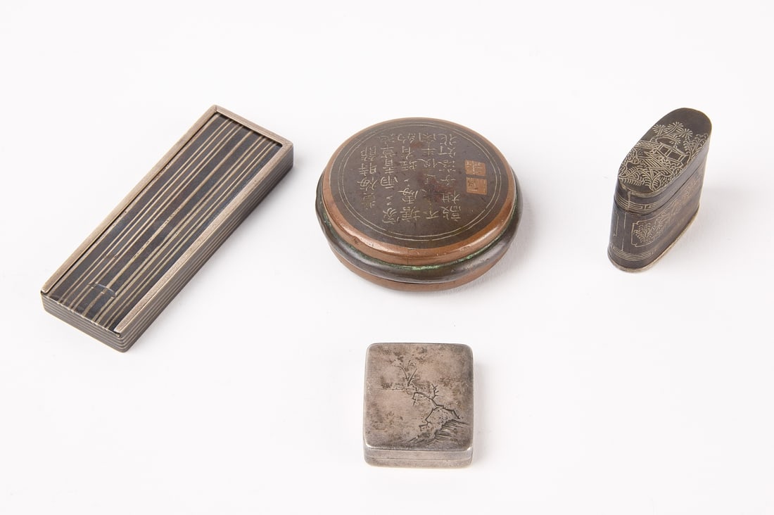 Four Japanese Pieces: Four Japanese pieces. Japanese silver pill box decorated with cherry tree. Art Deco match holder with striped cover and Japanese makers stamp. Silver plate on copper oval match safe. Round copper and