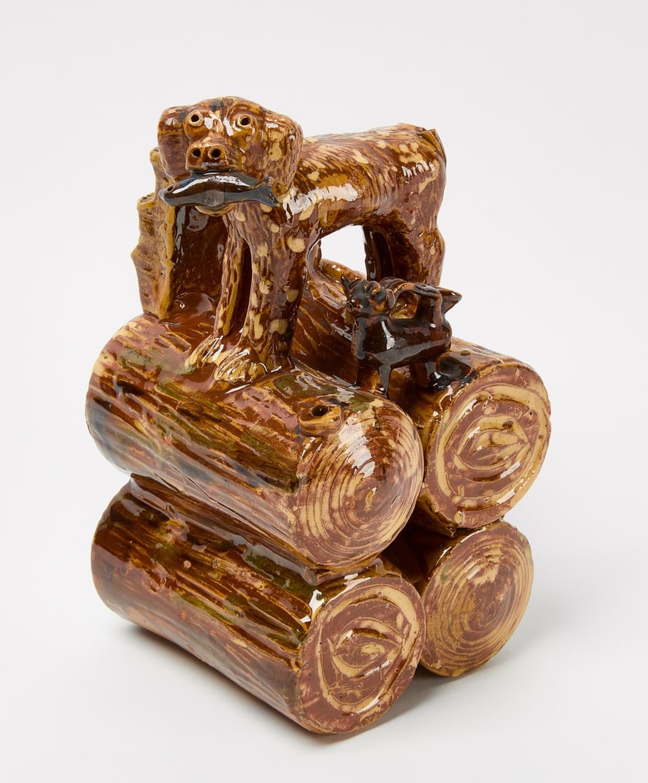 Pottery Folk Art of Dog on Logs: Earthenware folk art sculpture of a dog standing on top of a pile of logs. H 9-1/4" W 6-1/8" D 5-1/8". Condition: A couple of very minor chips. Link for high-res images: https://www.dropbox.com/scl/fo