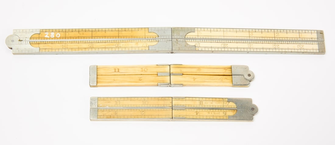 Three Foldable Bone Rulers: Three foldable bone rulers. Stanley Rule & Level Co. - 2' Ruler No. 89. bone and metal. New Britain, CT. When folded: H 6" W 1". E. S. Stearns & Co. - 1' Ruler No. 51 B. bone and metal. When folded: H