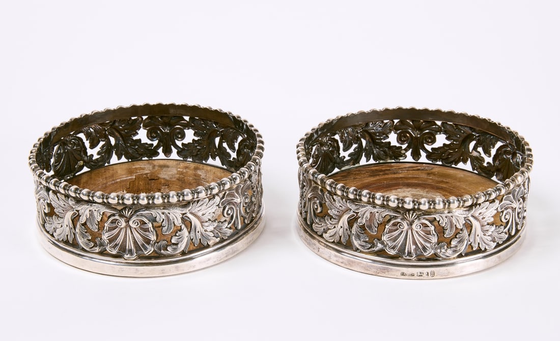 Pair of Sterling Wine Coasters: Pair of sterling wine coasters with wooden bottoms. English. 19th century. D 5-3/8". Condition: Some imperfections to wood. Estate of Thomas and Stephany Haines-Forsyth Wickes. Copy and paste link for
