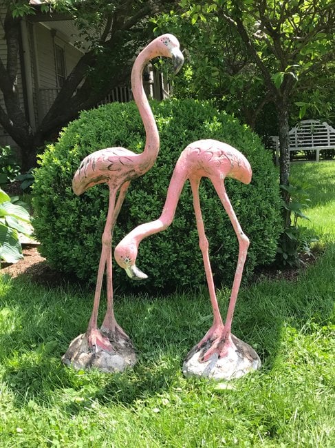 Pair if Cast Stone and Iron Flamingos: Pair of sculpted cast stone and iron flamingos. Old painted surface. Tall pink: H 39.5" D 15.75 " W 6.5". Short pink: H 27.5" D 19.5"