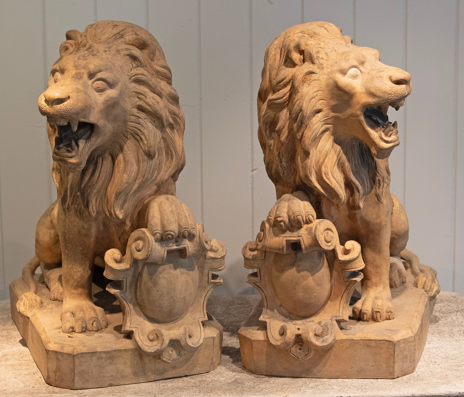 Pair of French Terracotta Armorial Lions, Signed "Garouste": This superbly-modeled and executed opposing pair of terracotta lions was crafted and signed by the well-known 19th C atelier of Jean Garouste in Castelnaudary, Southwestern France. Fabulous detailing,