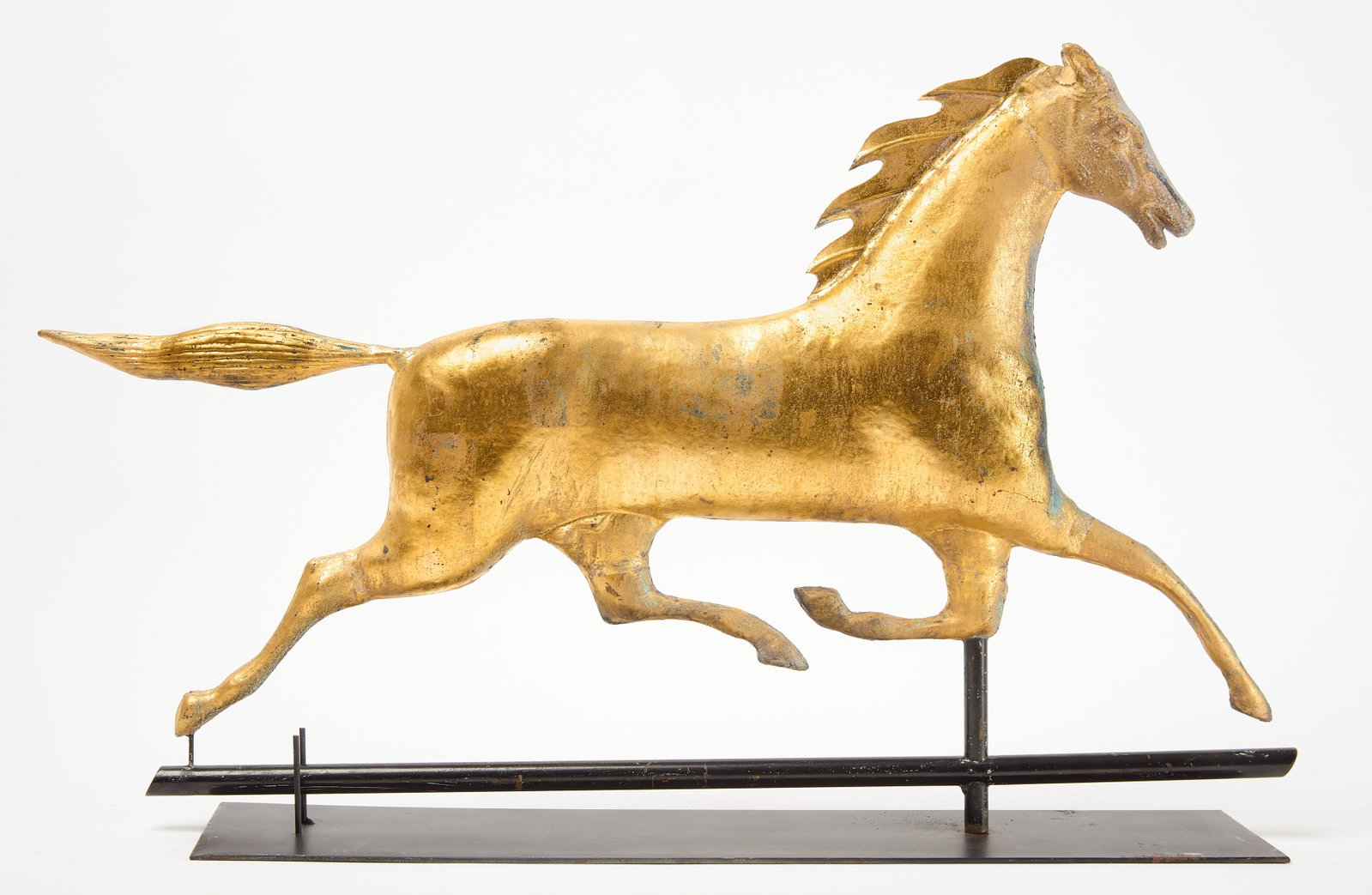 Running Horse Weathervane: Running horse weathervane. Molded copper with a cast zinc head. Historic gold gilt over earlier paint and verdigris. American, circa 1880. H 16" L 26" Condition: Structurally original. Later